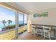 Bright room with a desk features stunning water views through expansive windows, inviting relaxation at 6400 Flotilla Dr # 87, Holmes Beach, FL 34217