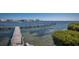 Scenic waterfront view featuring a private wooden pier and serene water, perfect for boating enthusiasts at 6400 Flotilla Dr # 87, Holmes Beach, FL 34217