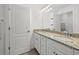 Bathroom featuring double sinks, granite countertops, and a large mirror with vanity lighting at 6535 Clairborne Ln, Bradenton, FL 34211