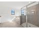 Bright bathroom featuring a large walk-in shower with glass door, a soaking tub, and a window at 6535 Clairborne Ln, Bradenton, FL 34211