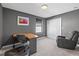 Cozy bedroom with gray walls, a desk, a comfortable chair, and a closet with double doors at 6535 Clairborne Ln, Bradenton, FL 34211