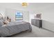 Serene bedroom featuring a gray bed, a view of the lake, and a matching dresser at 6535 Clairborne Ln, Bradenton, FL 34211