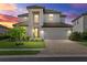 Beautiful two-story home with a tile roof, manicured lawn, and brick paved driveway at 6535 Clairborne Ln, Bradenton, FL 34211