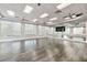 Bright fitness room with wood floors, mirrored wall, ceiling fans, and large windows providing ample natural light at 6535 Clairborne Ln, Bradenton, FL 34211
