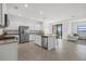 Bright kitchen features stainless appliances, granite countertops, and a large island with seating at 6535 Clairborne Ln, Bradenton, FL 34211