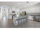 Bright eat-in kitchen features stainless appliances, granite countertops, and a large island with seating at 6535 Clairborne Ln, Bradenton, FL 34211