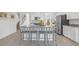 Bright eat-in kitchen features stainless appliances, granite countertops, and a large island with seating at 6535 Clairborne Ln, Bradenton, FL 34211