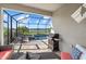 Covered patio next to the pool area, with a grill and outdoor seating for relaxation at 6535 Clairborne Ln, Bradenton, FL 34211