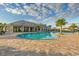 Resort-style pool with brick paver deck, lounge chairs, and a view of the clubhouse at 6535 Clairborne Ln, Bradenton, FL 34211