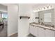 Bright bathroom with dual sinks, granite countertop, decorative shelving and updated fixtures at 7322 34Th E Ct, Sarasota, FL 34243