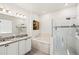 Bathroom with a soaking tub, glass enclosed shower, double sink vanity, and natural light at 7322 34Th E Ct, Sarasota, FL 34243