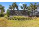 Community entrance sign for Grady Pointe, framed by palm trees and landscaping at 7322 34Th E Ct, Sarasota, FL 34243