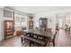 Dining room with wood floors, large table with bench seating, and two display cabinets at 7322 34Th E Ct, Sarasota, FL 34243