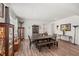 Spacious dining room with wood floors, large table, bench seating, and two display cabinets at 7322 34Th E Ct, Sarasota, FL 34243