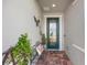 Cozy front porch with brick flooring, seating, and decorative butterfly art piece at 7322 34Th E Ct, Sarasota, FL 34243