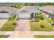 Inviting single-story home with brick driveway, lush lawn and pretty landscaping near the lake at 7322 34Th E Ct, Sarasota, FL 34243