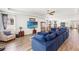 Spacious living room featuring a large blue sectional and wood flooring throughout the downstairs at 7322 34Th E Ct, Sarasota, FL 34243
