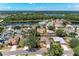 Aerial view of a residential community surrounded by lush greenery and a serene lake at 7814 48Th E Ave, Bradenton, FL 34203