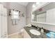 Updated bathroom with granite countertop, decorative mirror and wall art at 7814 48Th E Ave, Bradenton, FL 34203