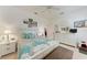 Bright bedroom features light walls, floral comforter, white furniture, and personal art at 7814 48Th E Ave, Bradenton, FL 34203