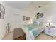 Bright bedroom features light walls, floral comforter, white furniture, and personal art at 7814 48Th E Ave, Bradenton, FL 34203