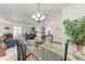 Bright dining room with glass table, chandelier, and open floor plan to living room with a view to the patio at 7814 48Th E Ave, Bradenton, FL 34203