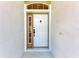 A white front door with decorative window and a black door knocker for curb appeal at 7814 48Th E Ave, Bradenton, FL 34203