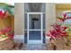 A welcoming screened entryway with decorative plants leading to the front door at 7814 48Th E Ave, Bradenton, FL 34203