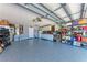 Spacious garage with epoxy floor, storage shelves, and tools, providing ample space for storage and projects at 7814 48Th E Ave, Bradenton, FL 34203