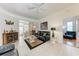 Cozy living space featuring a smooth transition to the lanai and a hallway to additional bedrooms at 7814 48Th E Ave, Bradenton, FL 34203