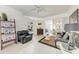 Open-concept living room with tile flooring, ceiling fan, and sliding glass doors to the lanai at 7814 48Th E Ave, Bradenton, FL 34203