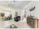 Open-concept living space with tile floors, a ceiling fan, and a partial view of the dining area at 7814 48Th E Ave, Bradenton, FL 34203