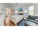 Beautiful main bedroom with a sliding glass door to the patio, light hardwood floors, and a stylish nautical theme at 7814 48Th E Ave, Bradenton, FL 34203