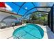 Inviting pool in screened enclosure features a dolphin sculpture and a tranquil backyard view at 7814 48Th E Ave, Bradenton, FL 34203