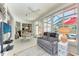 Enclosed sunroom featuring tile floors, dining table, ceiling fan and multiple seating areas at 7814 48Th E Ave, Bradenton, FL 34203