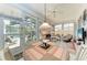 Inviting sunroom filled with natural light, a dining table and chairs overlooking the pool at 7814 48Th E Ave, Bradenton, FL 34203