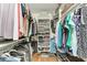 Walk-in closet with custom shelving and racks to maximize storage space, and wood floors at 7814 48Th E Ave, Bradenton, FL 34203
