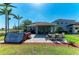 Wide backyard featuring outdoor patio, hot tub, and green lawn, great for outdoor entertaining at 8243 Nandina Dr, Sarasota, FL 34240