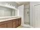 Modern bathroom featuring double vanity, an enclosed glass shower with detailed floor, and decorative lighting at 8243 Nandina Dr, Sarasota, FL 34240