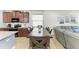 Open-concept kitchen and dining area with stainless appliances and adjacent Gathering room at 8243 Nandina Dr, Sarasota, FL 34240