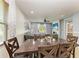 Comfortable dining area with a view of the backyard and flowing into the living room at 8243 Nandina Dr, Sarasota, FL 34240