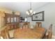 Formal dining room with elegant table, chairs, chandelier, and tile flooring at 8243 Nandina Dr, Sarasota, FL 34240
