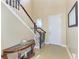 Inviting foyer with staircase, neutral walls, tile floor and decorative table at 8243 Nandina Dr, Sarasota, FL 34240