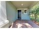 Welcoming front porch featuring brick flooring, an elegant door, and charming decor at 8243 Nandina Dr, Sarasota, FL 34240