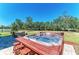 Luxurious hot tub, surrounded by outdoor seating, set against a backyard at 8243 Nandina Dr, Sarasota, FL 34240