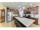 Spacious kitchen featuring a large granite island, stainless steel appliances, and ample cabinetry at 8243 Nandina Dr, Sarasota, FL 34240
