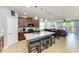 Bright open kitchen with a large center island, stainless appliances, and a view into the Gathering room at 8243 Nandina Dr, Sarasota, FL 34240
