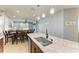 Modern kitchen island with a sink and seating, flowing into the dining and living spaces at 8243 Nandina Dr, Sarasota, FL 34240