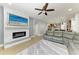 Living room featuring a fireplace, leather sectional, and an open layout that flows into the kitchen at 8243 Nandina Dr, Sarasota, FL 34240