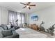 Inviting living room featuring a plush sofa, modern ceiling fan, and exercise equipment at 8243 Nandina Dr, Sarasota, FL 34240